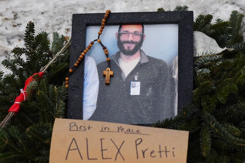 A picture of Alex Pretti is left at a makeshift memorial in the area where Pretti was shot dead a day earlier by federal immigration agents in Minneapolis, Minnesota, on January 25, 2026.