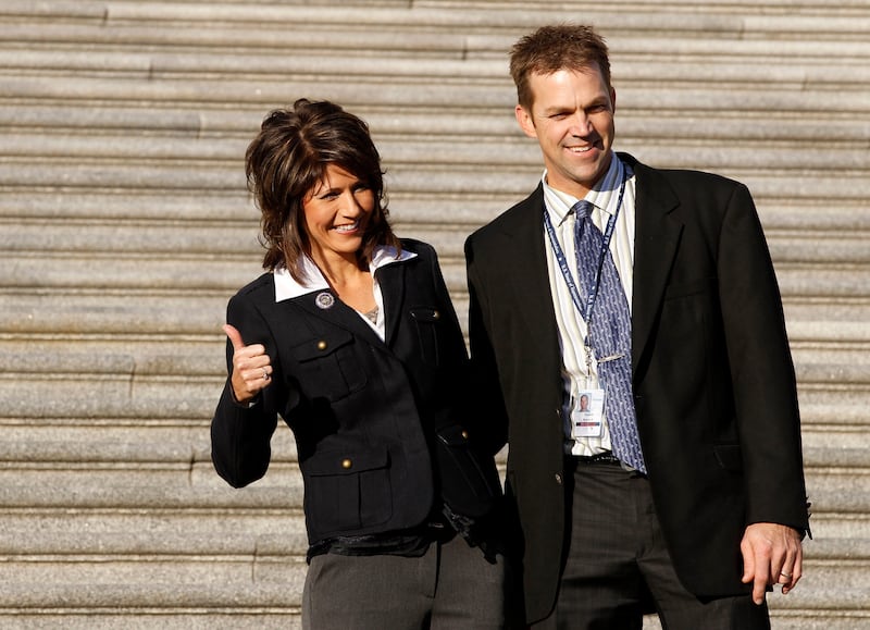 New House of Representative member Kristi Noem (L) poses with her husband, Bryon, on the House steps of the U.S. Capitol in Washington, November 19, 2010.      REUTERS/Larry Downing (UNITED STATES - Tags: POLITICS)