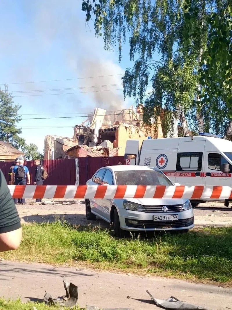 An ambulance stands near a damaged private house following a Ukrainian drone attack, according to regional authorities, in the course of the Russia-Ukraine conflict, in the town of Yegoryevsk, Moscow region, Russia, in this handout image released on June 30, 2026.