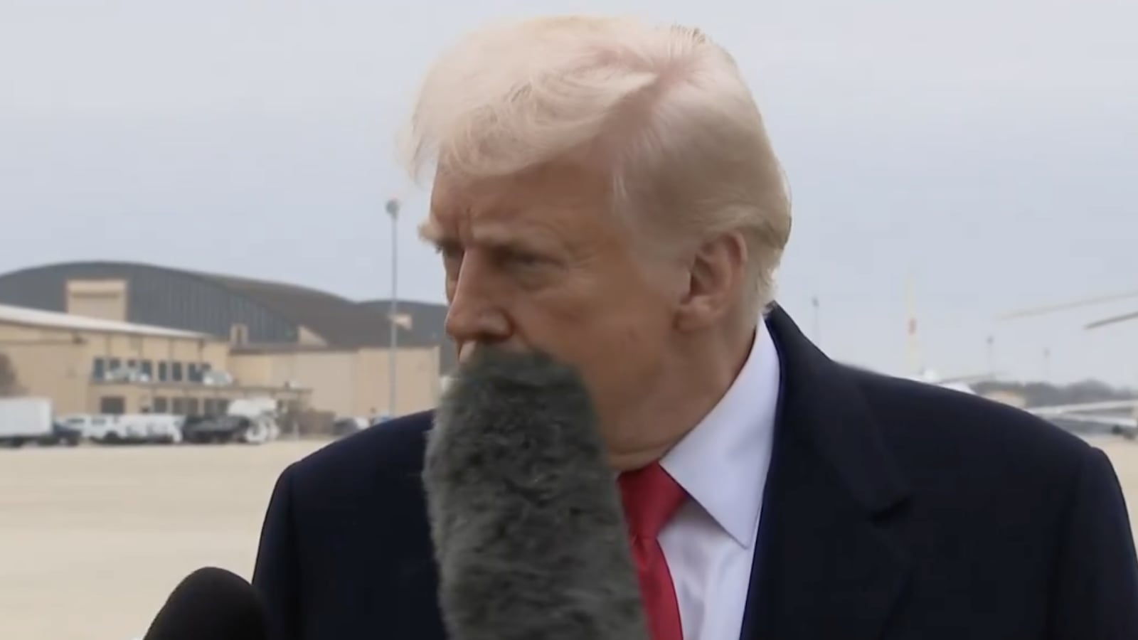 Donald Trump gets hit in the face with a boom mic while talking to reporters.