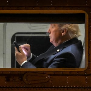US President Donald Trump uses a cellphone