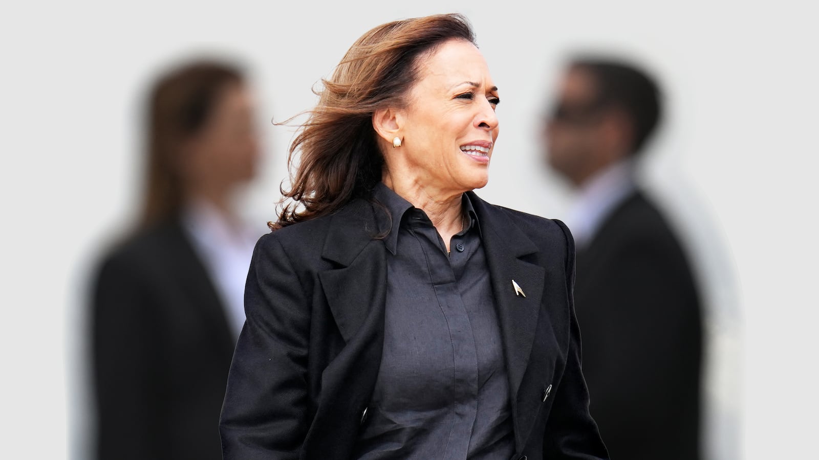 A photo illustration of Kamala Harris and Secret Service agents.