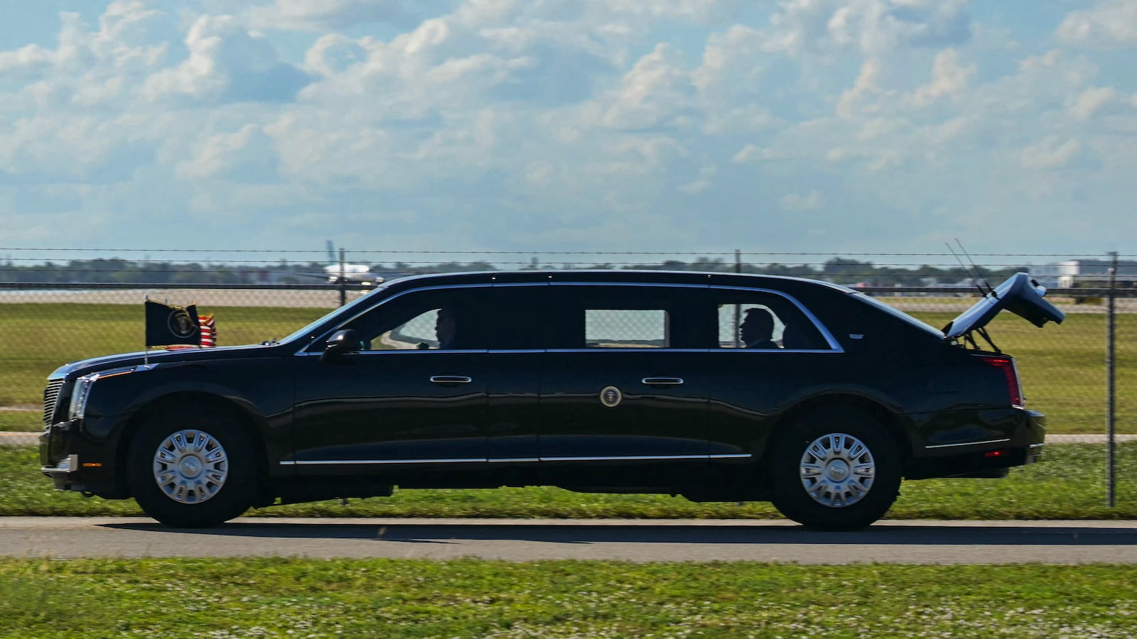 The US President's official vehicle known as "The Beast", drives with its trunk open, as US President Donald Trump's motorcade travels to Palm Beach International Airport in West Palm Beach, Florida, on November 9, 2025. Trump is returning to Washington DC after spending part of the weekend at his Florida residence of Mar-a-Lago. (Photo by Jim WATSON / AFP) (Photo by JIM WATSON/AFP via Getty Images)