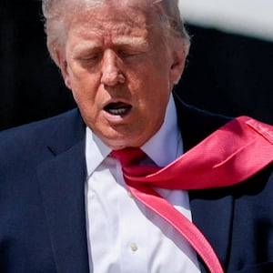 U.S. President Donald Trump's tie is blown by the wind as he walks to board Air Force One for his trip to Las Vegas, Nevada, as he departs Joint Base Andrews, Maryland, U.S., on the day he announced that Israeli and Lebanese leaders had agreed to begin a 10-day ceasefire, April 16, 2026. REUTERS/Evan Vucci     TPX IMAGES OF THE DAY