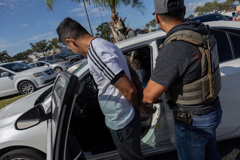 Federal agents arrest a man in an immigration enforcement operation