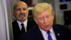 U.S. Commerce Secretary Howard Lutnick stands behind President Trump on Air Force One