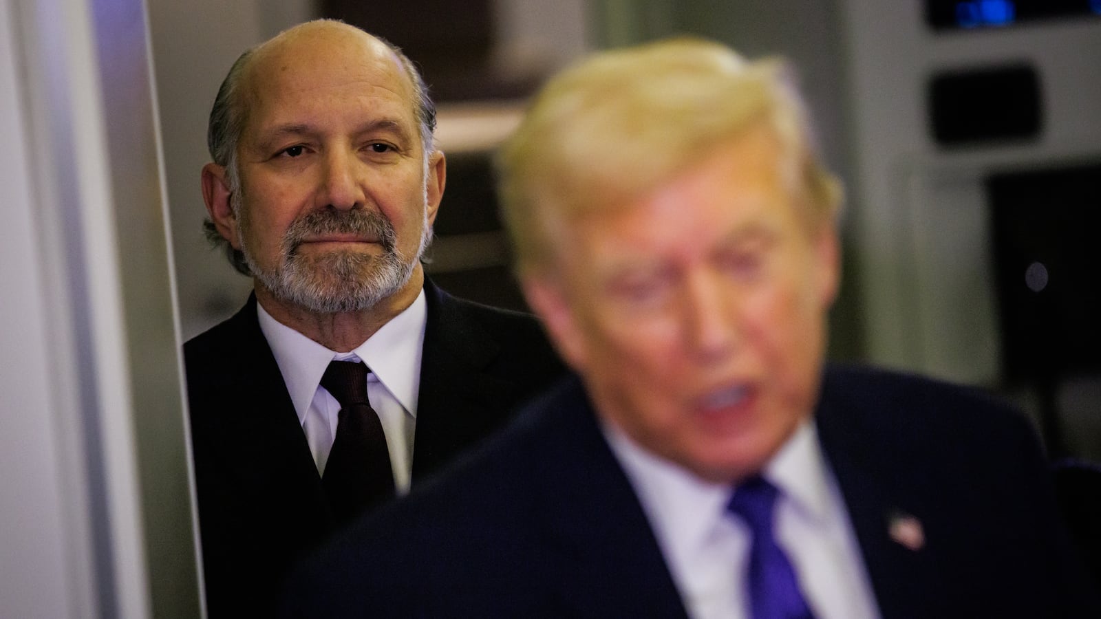 U.S. Commerce Secretary Howard Lutnick stands behind President Trump on Air Force One