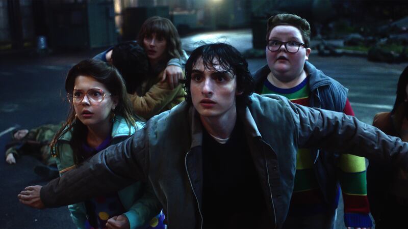(L-R) Winona Ryder as Joyce Byers, Finn Wolfhard as Mike Wheeler, and Jake Connelly as Derek.