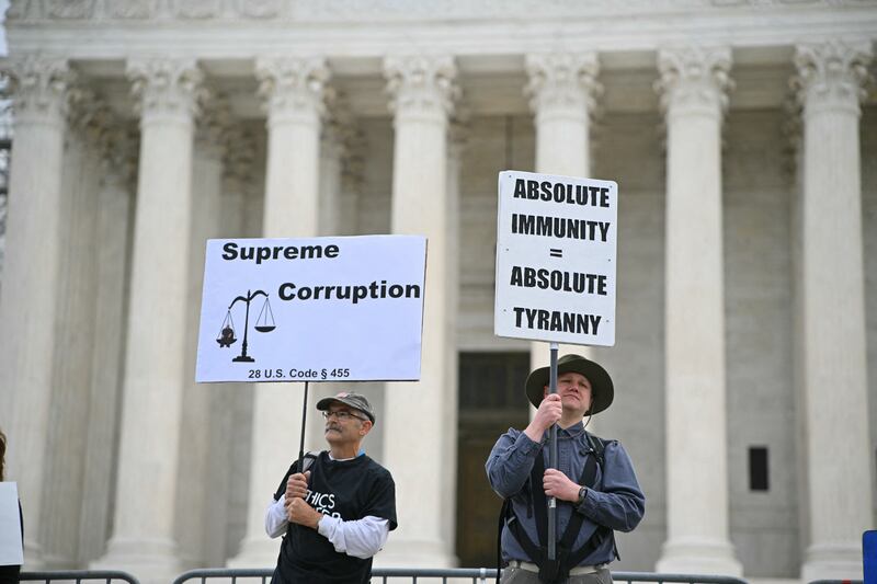 Protesters demonstrate outside the U.S. Supreme Court on April 25, 2024, as the court prepares to hear arguments on the immunity of former President Donald Trump, in Washington, D.C.