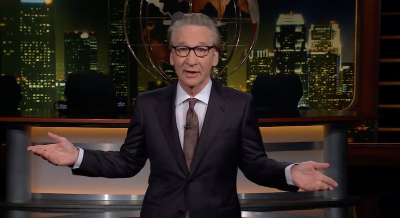 Bill Maher stands on the set of his eponymous late-night show during the monologue segment.