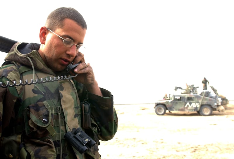 US Marine First Lt. Walter Giardina, "convoy commander," for a massive train of Marine vehicles that are making their may towards Bagdad talks on the radio Tuesday morning, Iraq time.