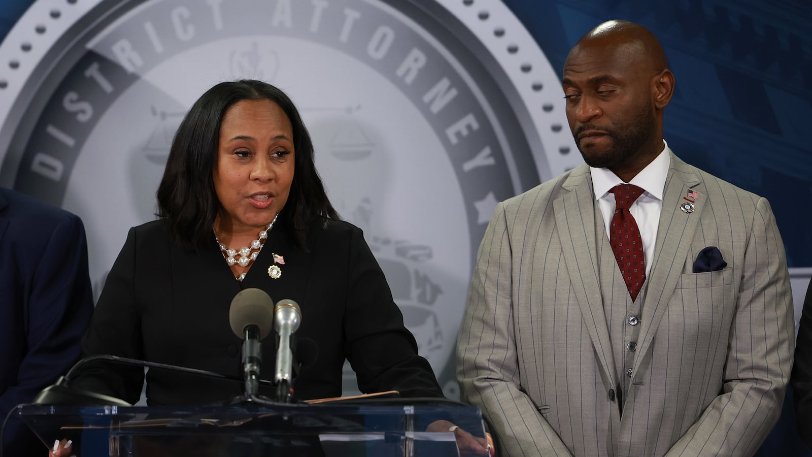 Fulton County District Attorney Fani Willis stands next to Nathan Wade.