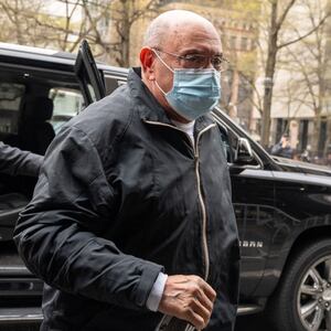 Allen Weisselberg, dressed in all black and wearing a surgical mask, walks into court.