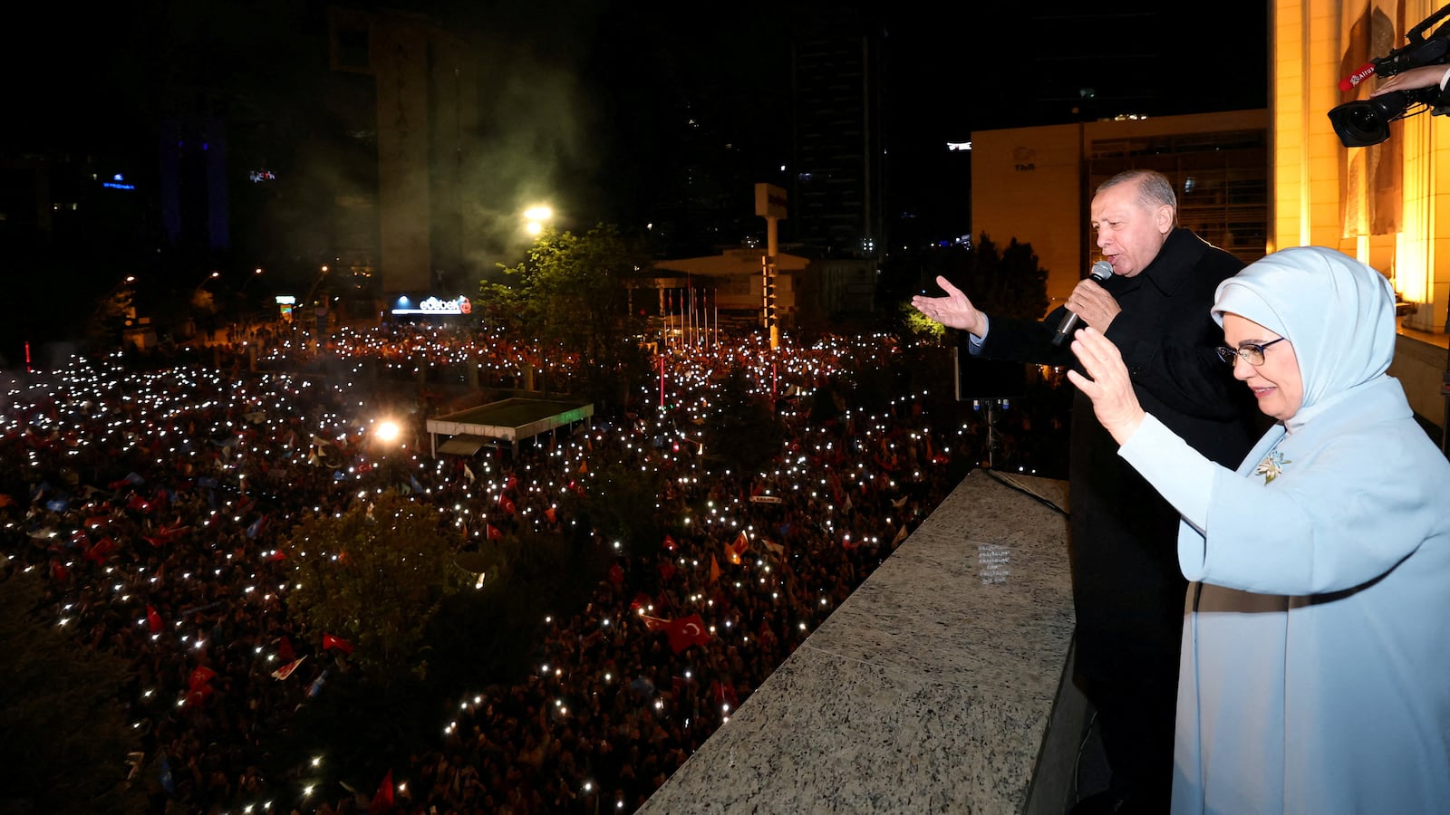Turkish President Tayyip Erdogan, accompanied by his wife, Emine Erdogan, addresses his supporters at the AK Party headquarters in Ankara, Turkey, May 15, 2023.