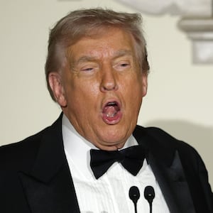 U.S. President Donald Trump delivers remarks as first lady Melania Trump looks during the Congressional Ball at the Grand Foyer of the White House on December 11, 2025 in Washington, DC.