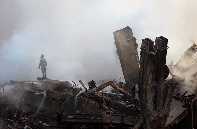 A lone worker stands amid the ruins of the World Trade Center as work continues at Ground Zero 11 October, 2001 in New York City.