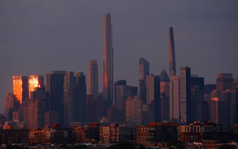 JERSEY CITY, NJ - JULY 21: The sun sets on the Deutsche Bank Center in Columbus Circle and buildings along Billionaires Row in New York City on July 21, 2025, as seen from Jersey City, New Jersey.