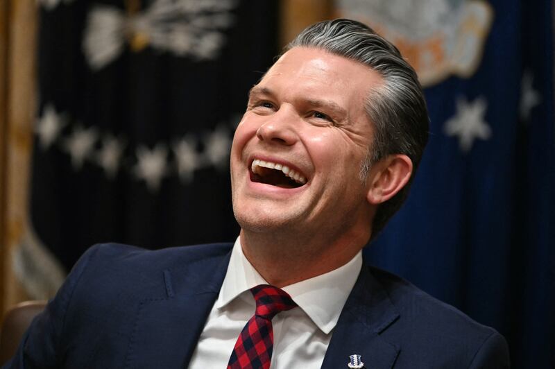 Defense Secretary Pete Hegseth laughs during a Cabinet Meeting hosted by President Donald Trump at the White House in Washington, DC on December 2, 2025.