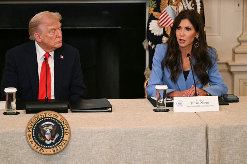US President Donald Trump listens to Homeland Security Secretary Kristi Noem during a roundtable about Antifa in the State Dining Room of the White House in Washington, DC, on October 8, 2025. (Photo by Jim WATSON / AFP) (Photo by JIM WATSON/AFP via Getty Images)