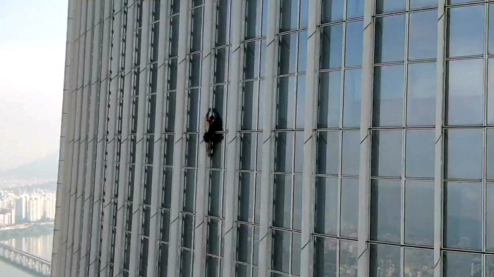 A British man climbs South Korea’s tallest building, the 123-story Lotte World Tower, without a rope before being forced to abandon the climb more than halfway up, in Seoul, South Korea, June 12, 2023.