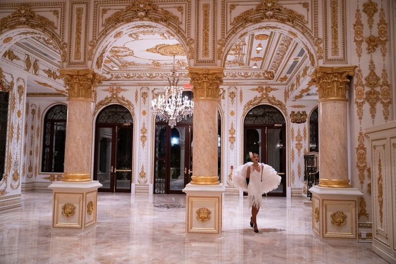 A dancer walks through an hall at President Donald Trump's residence of Mar-a-Lago during a Halloween party in Palm Beach, Florida on October 31, 2025.