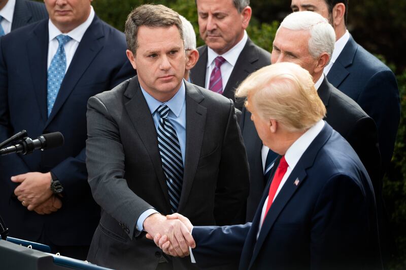 Doug McMillon shaking hands with Donald Trump