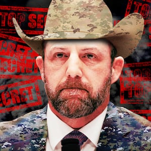 A photo illustration of Markwayne Mullin in camouflage, cowboy hat, and top secret stamps.