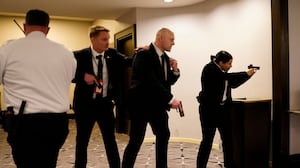 Federal agents draw their guns out after an incident at the annual White House Correspondents Association Dinner April 25, 2026 in Washington, DC. According to reports, President Donald Trump, along with other government officials, were evacuated from the Washington Hilton after what sounded like gun fire.