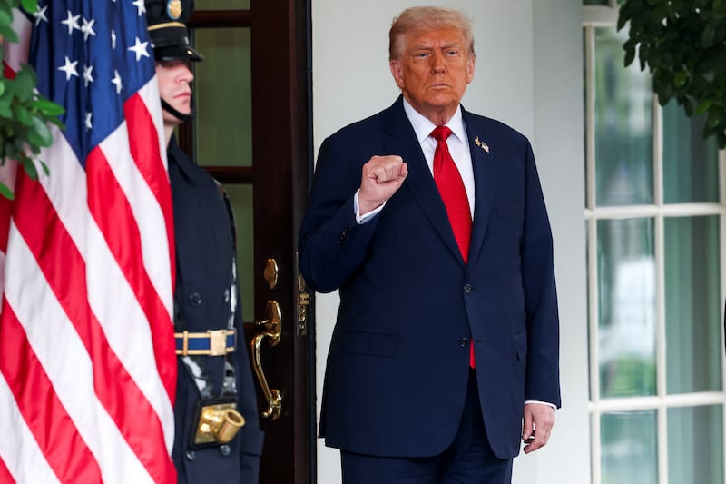 President Donald Trump gestures as he waits to welcome Turkey's President Recep Tayyip Erdogan to the White House in Washington, D.C. on September 25, 2025.