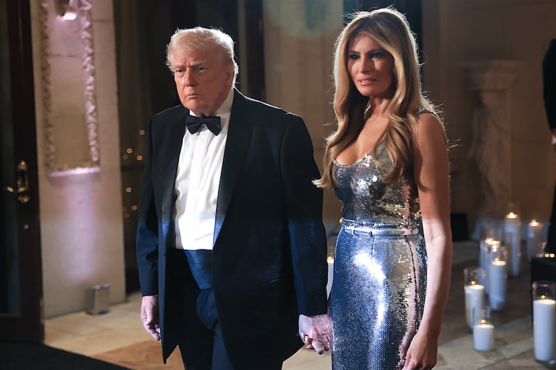 U.S. President Donald Trump and first lady Melania Trump arrive for a New Year’s Eve event at his Mar-a-Lago home on December 31, 2025 in Palm Beach, Florida.