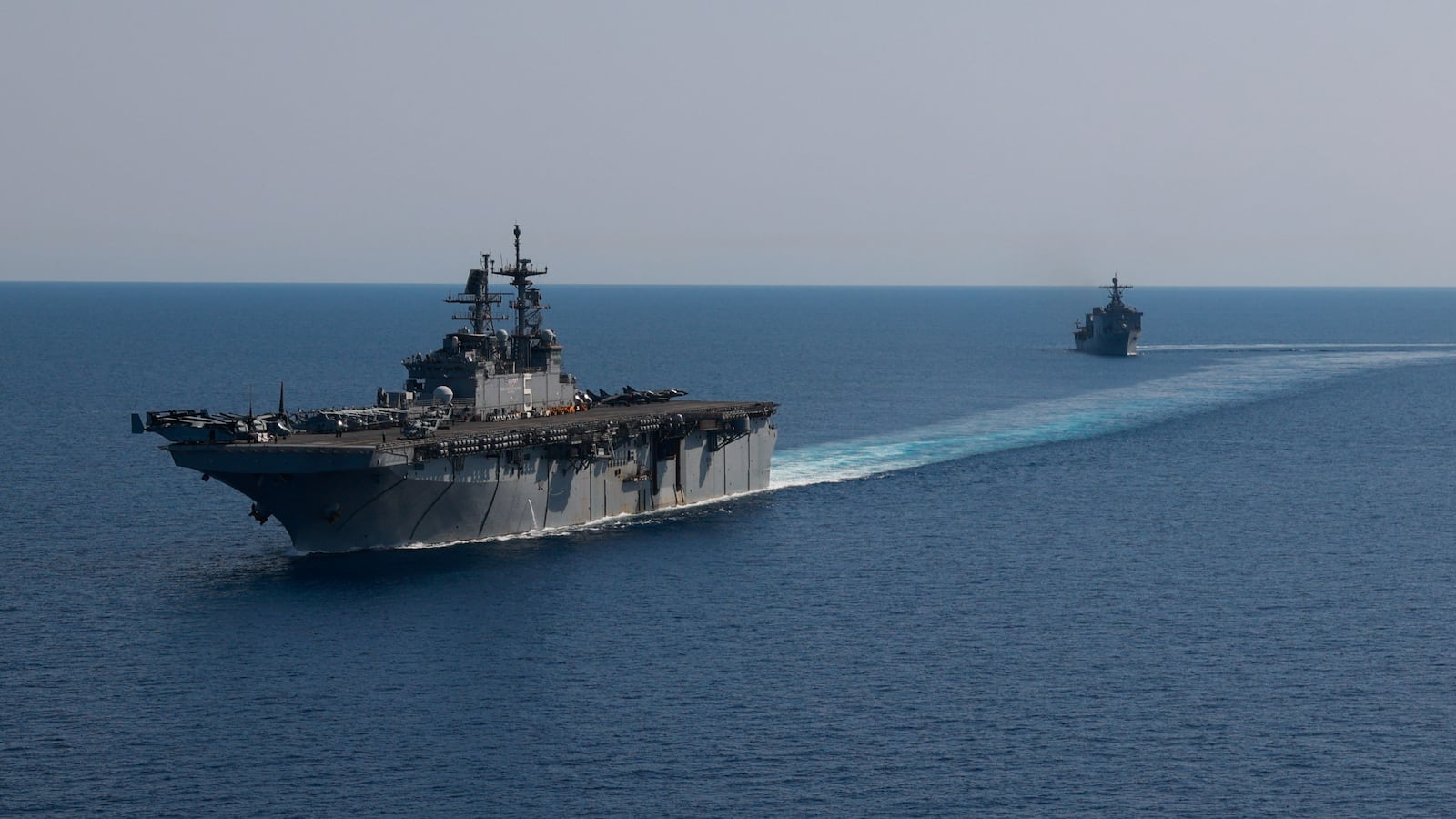 Amphibious assault ship USS Bataan (LHD 5) and dock landing ship USS Carter Hall (LSD 50) sail together in the Red Sea, in this photo taken on August 8, 2023.