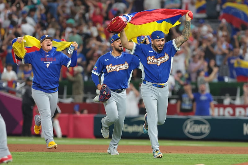 Venezuela pitcher José Buttó (70) and teammates celebrate after defeating Italy in a semifinal game of the 2026 World Baseball Classic at loanDepot Park.