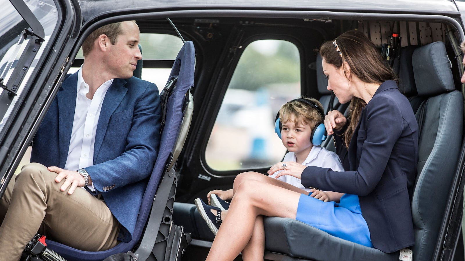 TOPSHOT - Britain's Prince George (2nd L) sits in a 'Squirrel' helicopter with his mother Catherine, Duchess of Cambridge and father Prince William during a visit to the Royal International Air Tattoo at RAF Fairford in western England, on July 8, 2016. (Photo by RICHARD POHLE / POOL / AFP) (Photo by RICHARD POHLE/POOL/AFP via Getty Images)