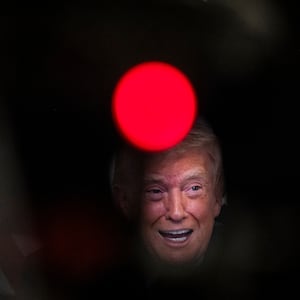 President Donald Trump participates in a call with U.S. service members from his Mar-a-Lago club