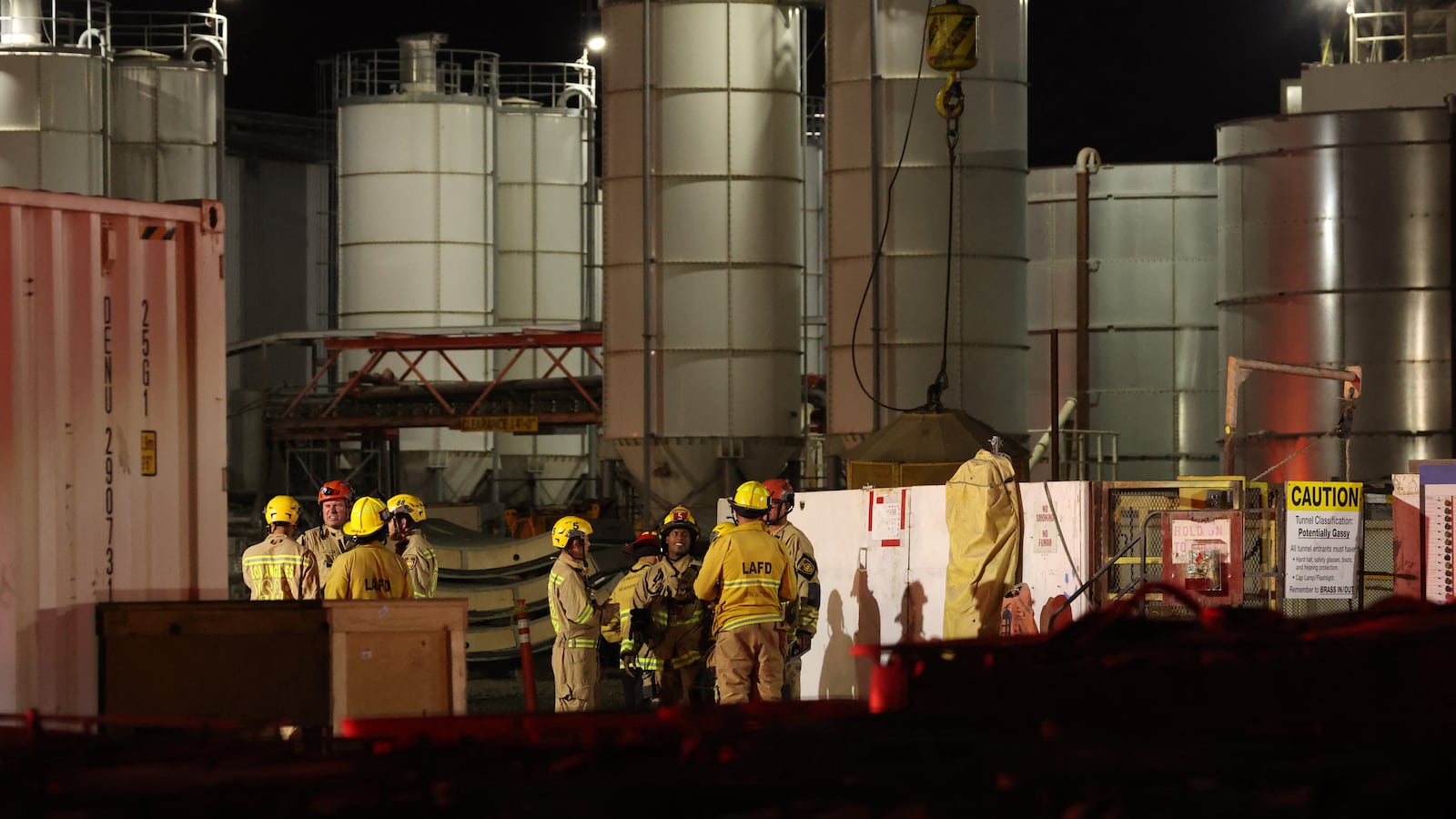 Los Angeles Fire Department (LAFD) firefighters are seen at the site of an industrial tunnel collapse in the Wilmington neighborhood of Los Angeles on July 9, 2025. 31 workers were safely removed from the tunnel without visible injuries, the LAFD said on July 9. (Photo by Patrick T. Fallon / AFP) (Photo by PATRICK T. FALLON/AFP via Getty Images)
