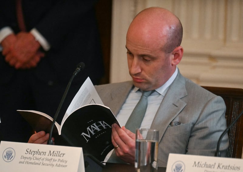 White House deputy chief of staff for policy and US homeland security advisor Stephen Miller reads a MAHA report as US President Donald Trump holds a MAHA (Make America Healthy Again) Commission Event in the White House in Washington, DC, on May 22, 2025. (Photo by Jim WATSON / AFP) (Photo by JIM WATSON/AFP via Getty Images)