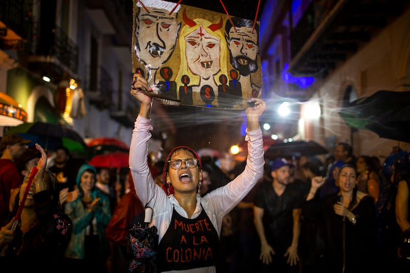 Protestors demand the resignation of Puerto Rico's Governor Wanda Vázquez Garced (center in the sign) and Senate President Thomas Rivera Shatz (left on the sign) during new protests in front of the governor's mansion on January 23, 2020 in San Juan, Puerto Rico.
