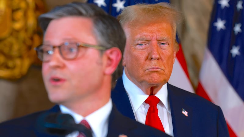 President Donald Trump listens as  Mike Johnson speaks during a press conference at Mr. Trump's Mar-a-Lago estate on April 12, 2024, in Palm Beach, Florida.