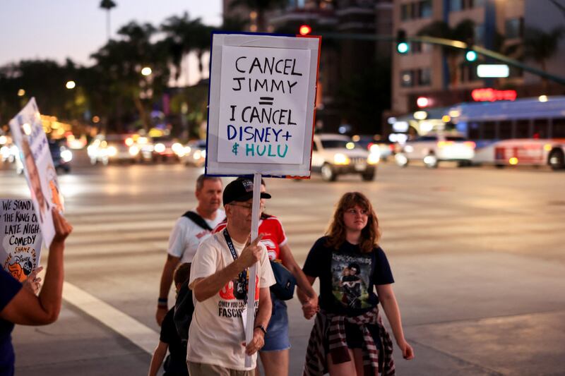People take part in a protest outside Disneyland after Jimmy Kimmel's late-night talk show was suspended for remarks he made regarding Charlie Kirk's assassination, in Anaheim, California, U.S. September 19, 2025. REUTERS/David Swanson