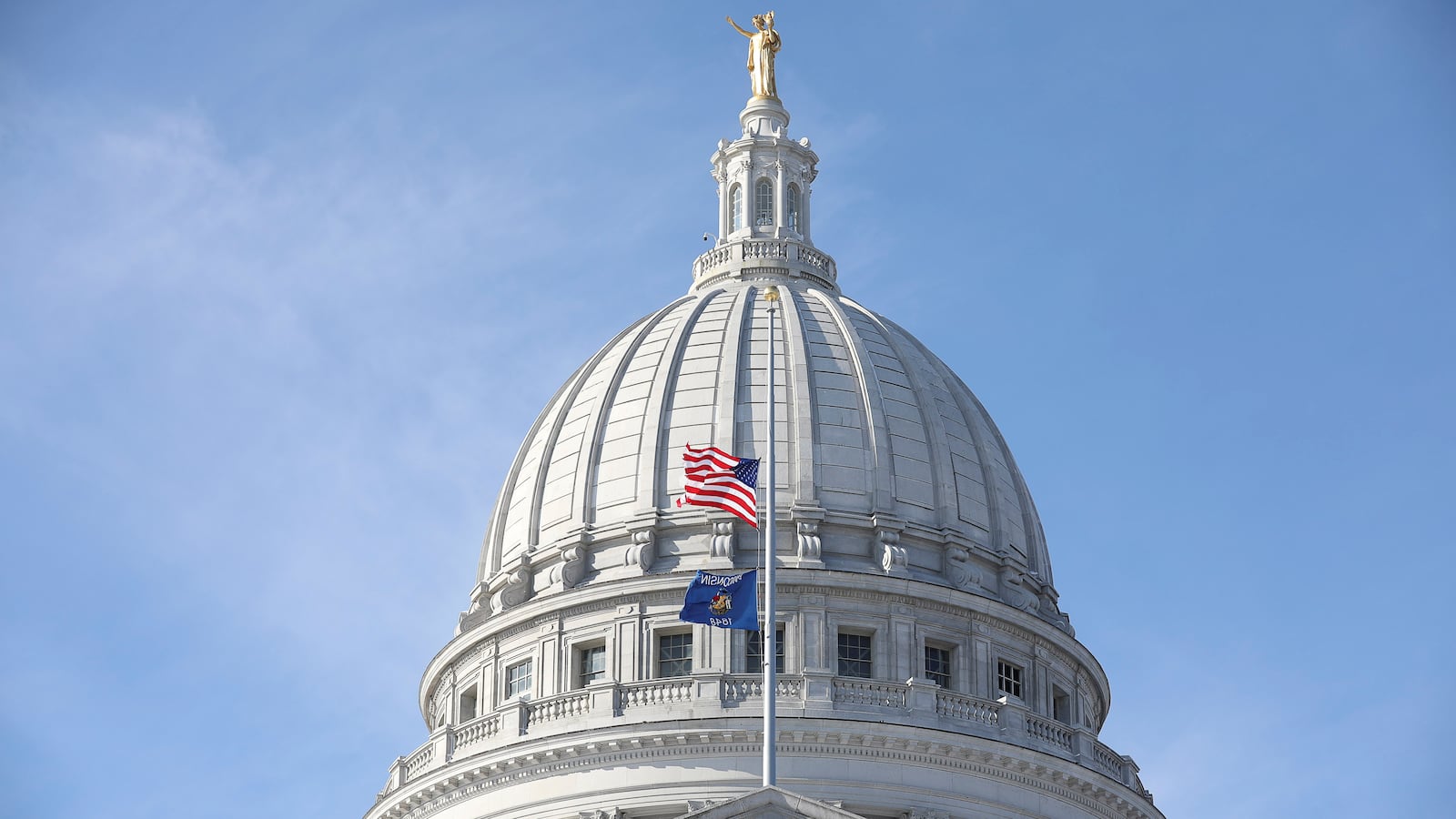 American and Wisconsin state flags fly outside as Wisconsin electors gather to cast their votes for the U.S. presidential election at the Wisconsin State Capitol in Madison, Wisconsin, U.S., December 14, 2020.