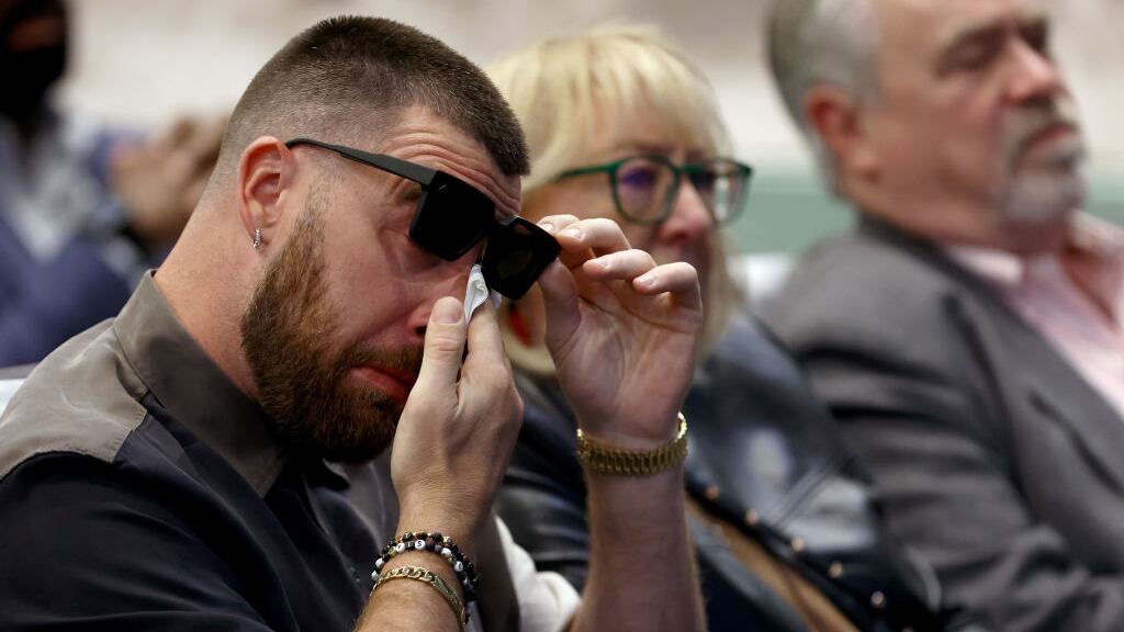 Travis Kelce dabs his eyes during his brother Jason Kelce’s retirement announcement.