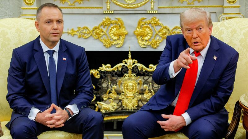 U.S. President Donald Trump points a finger while sitting next to the President of Poland Karol Nawrocki during a meeting in the Oval Office at the White House in Washington, D.C., U.S., September 3, 2025.  REUTERS/Brian Snyder
