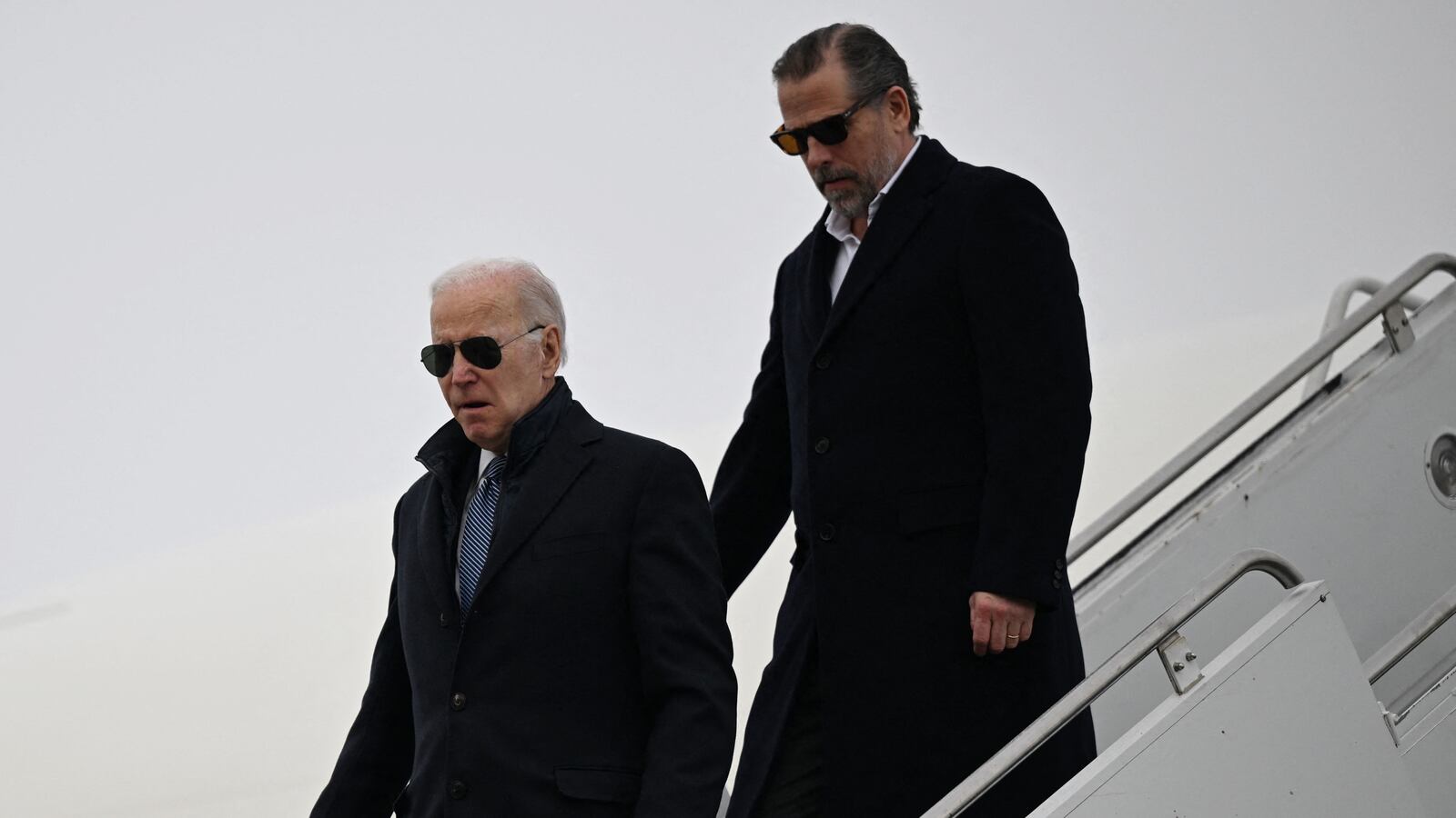 Joe Biden and Hunter Biden walking down stairs from a plane.