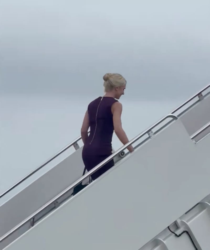 Natalie Harp walks up the steps of Air Force One on Monday.