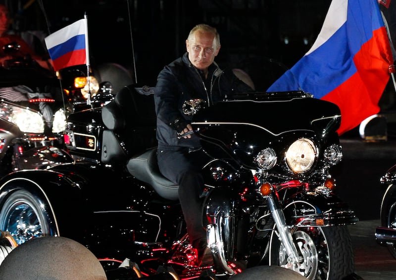 Russian Prime Minister Vladimir Putin rides a motorcycle on August 29, 2011 at a bikers' festival in the Black Sea port of Novorossiysk, Russia. Putin described leather-clad bikers as brothers and boasted of the "indivisible Russian nation" after roaring into a biking rally on a Harley Davidson. AFP PHOTO / IVAN SEKRETAREV (Photo by IVAN SEKRETAREV / POOL / AFP) (Photo by IVAN SEKRETAREV/POOL/AFP via Getty Images)