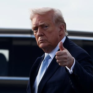 U.S. President Donald Trump gestures with a thumbs up as he steps from Air Force One upon his arrival in West Palm Beach, Florida