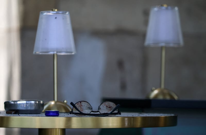 Broken glasses lie on a table inside the fenced-off Balzi Rossi Italian restaurant following a deadly bomb explosion in central Moscow, Russia, August 2, 2026. Russia's National Anti-Terrorism Committee said the previous day that the bomb was carried by an unidentified woman who attempted to enter the restaurant and was stopped by a security guard. REUTERS/Anastasia Barashkova