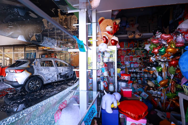 GUADALAJARA, MEXICO - FEBRUARY 22: A burnt car crashes the entrance of a store at a shopping center on February 22, 2026 in Guadalajara, Mexico. Road blockades and vehicle burnings have been reported in several parts of Mexico since early morning. The Secretariat of National Defense of Mexico has confirmed that during a security operation in Tapalpa, Jalisco,  Nemesio Oseguera Cervantes, known as 'El Mencho' leader of the Jalisco New Generation Cartel was killed, along with four other members. Three Mexican soldiers were wounded during the operation. (Photo by Carlos Zepeda/Getty Images)