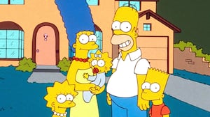 A still of a 90s episode of The Simpsons shows the entire Simpsons family posing outside of their house.