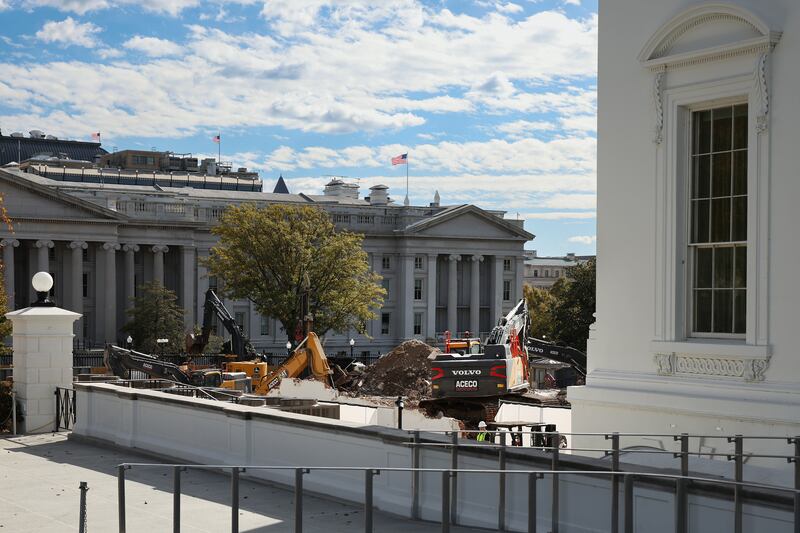 Excavators work to clear debris after the East Wing of the White House was demolished